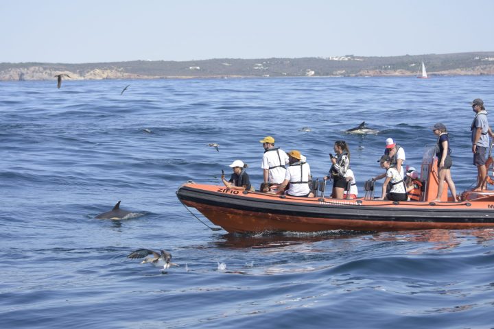 a group of people in a boat on a body of water