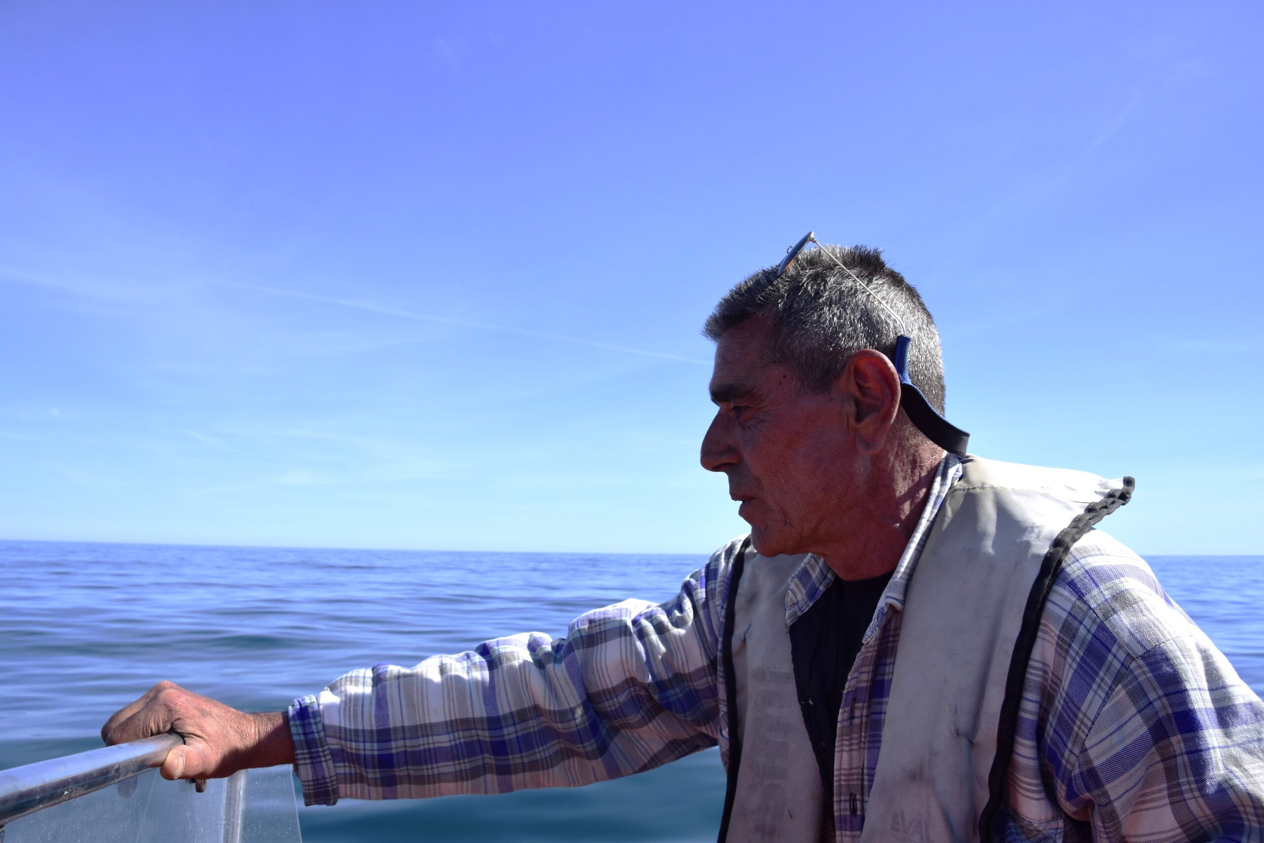 a man standing next to a body of water