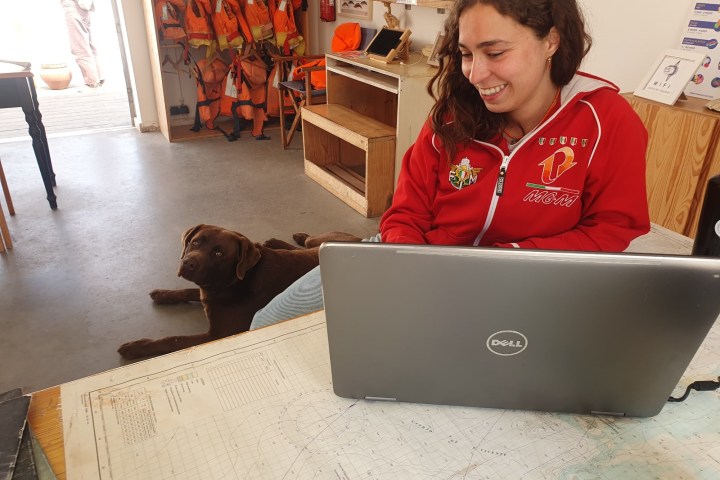 a person sitting in front of a laptop computer